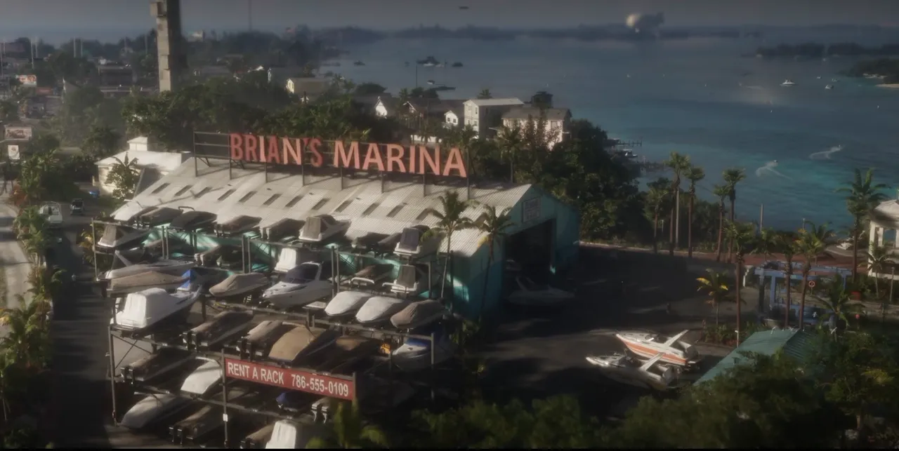 「BRIAN'S MARINA」の看板を掲げたマリーナを上空から見た風景。棚に多くのボートが並び、奥には海と小島が広がっている（ローンチトレーラーより）