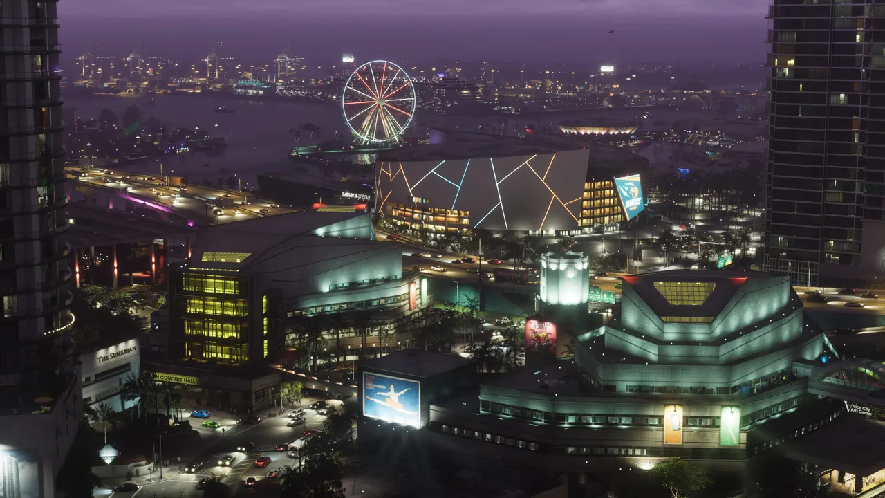 夜のVice Cityを上空から捉えた公式スクリーンショット。観覧車やネオンに照らされた建物が密集し、その間を道路が走っている