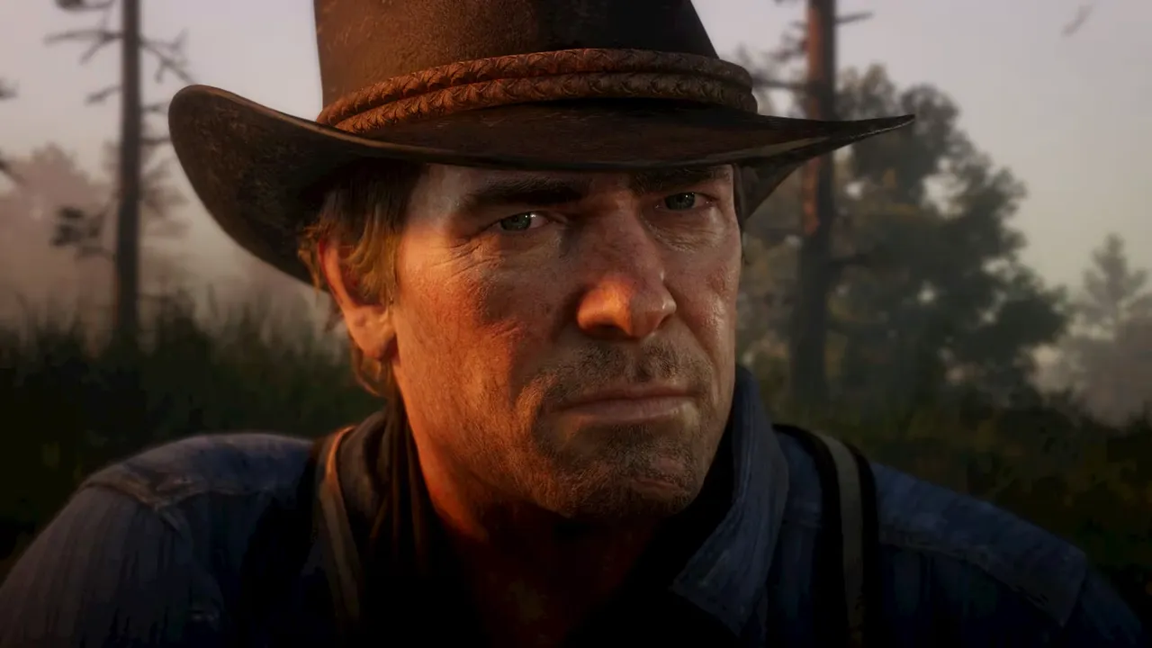 カウボーイハットをかぶったアーサー・モーガンの顔のアップ。『Red Dead Redemption 2』の公式スクリーンショット